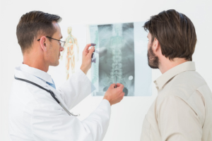 A man consults with a doctor about his spinal xray results following an auto accient.