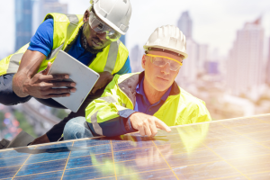 Two men inspect a solar panel in Miami